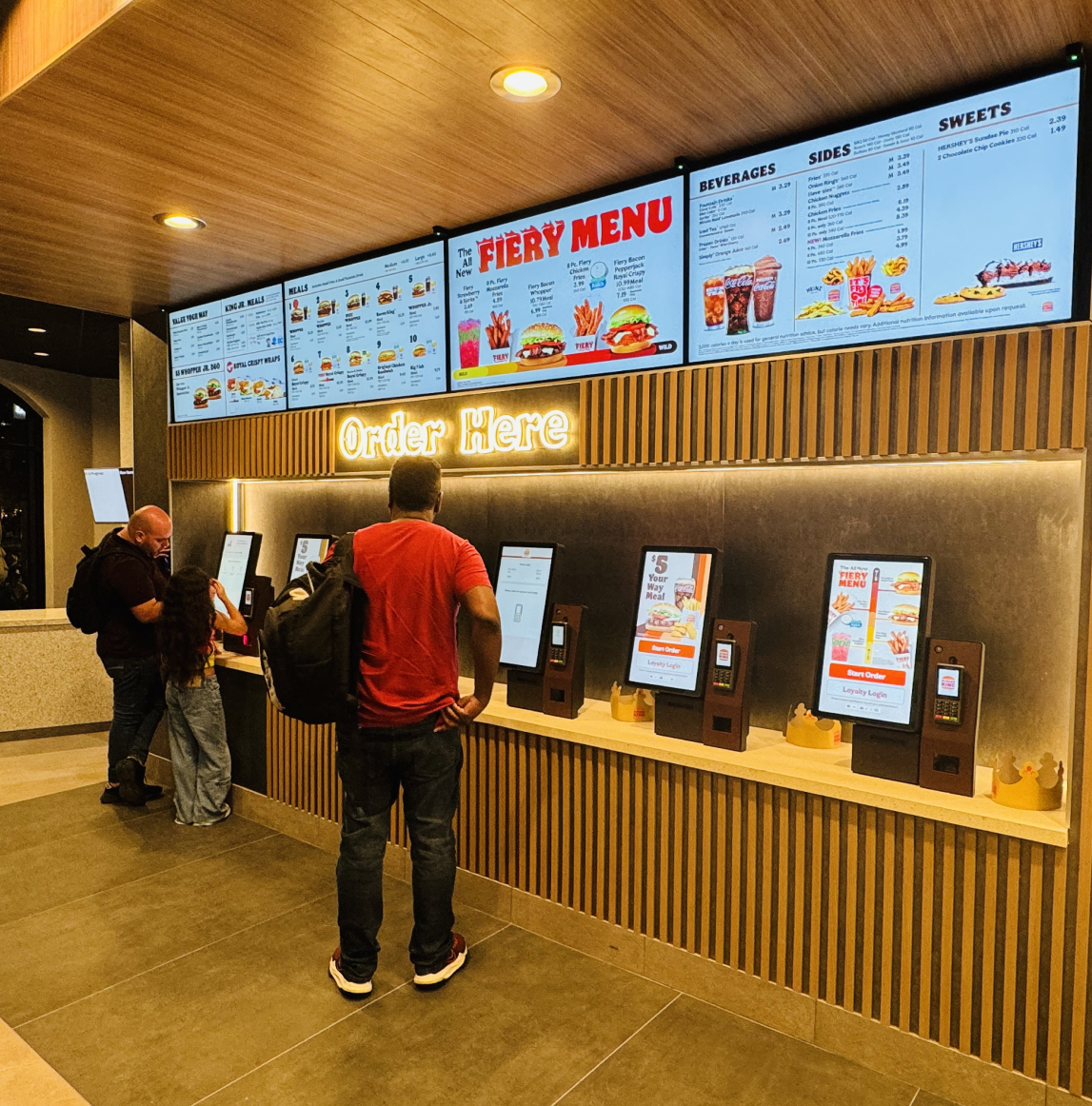 man in QSR using a self-service kiosk