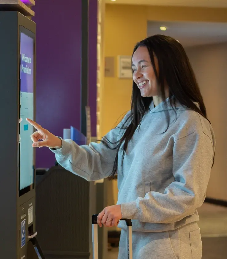 Image of a woman enjoying using the kiosk