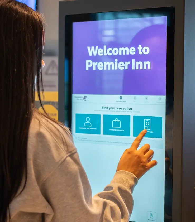 Image of a woman using kisok