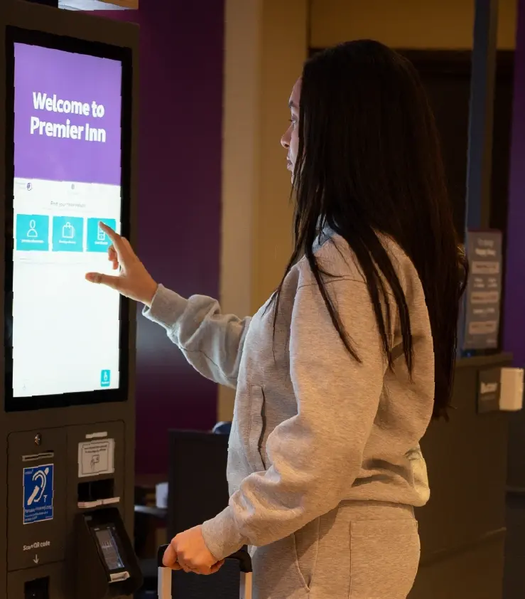 Image of a woman interacting with the kiosk UI